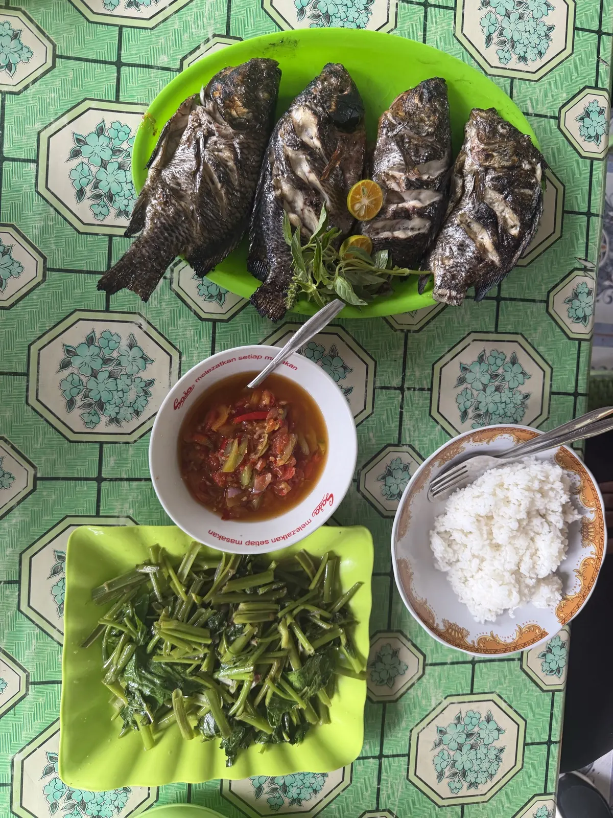 Grilled fish, dabu-dabu, kangkung and rice at a local restaurant